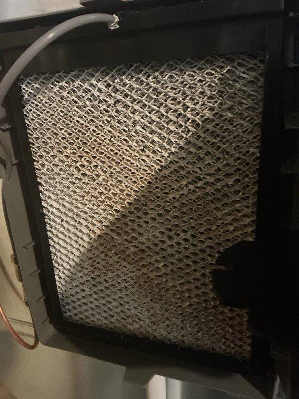 Completed scheduled Air Care Cooling maintenance visit involving inspection and replacement of HVAC system components. Replaced air filters showing standard use and installed new humidifier evaporator pad due to significant mineral scale buildup and deposits on the honeycomb mesh structure. System components inspected and serviced as part of recurring preventive maintenance program to ensure optimal air quality and equipment performance.