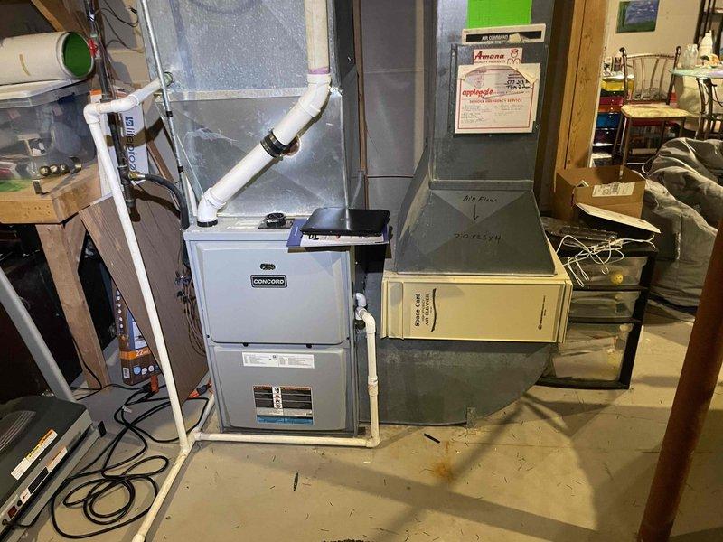Conducted on-site evaluation for complete air conditioning system replacement at single-family residence. Existing AC unit, approximately 25 years old, has been non-operational since previous fall season. Assessed current Concord furnace installation and existing ductwork configuration in basement mechanical room. Documented existing HVAC infrastructure including insulated ductwork, air handler cabinet, and PVC venting system. Provided comprehensive replacement quote for new cooling system to restore climate control functionality.