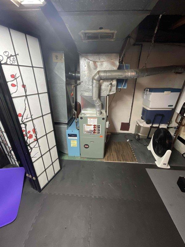 Conducted site assessment for central air conditioning system installation at residence with no existing AC. Evaluated basement mechanical room containing furnace and water heater, inspected existing ductwork infrastructure, and determined optimal equipment placement and distribution routing. Provided comprehensive estimate for complete central air system installation including outdoor condensing unit, evaporator coil integration with existing forced-air furnace, refrigerant lines, electrical connections, thermostat upgrade, and any necessary ductwork modifications to accommodate cooling distribution.