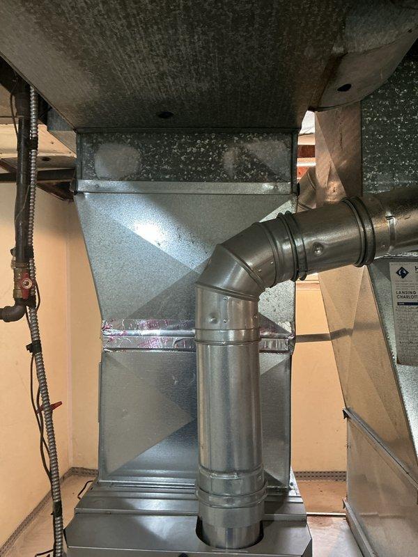 Completed annual maintenance on HVAC system including inspection of ductwork, air handler unit, and ventilation components in basement mechanical area. Documented existing ceiling moisture damage and mold growth above ductwork assembly for customer awareness. Verified all duct connections, insulation wrapping, and metallic components are properly secured and functional.