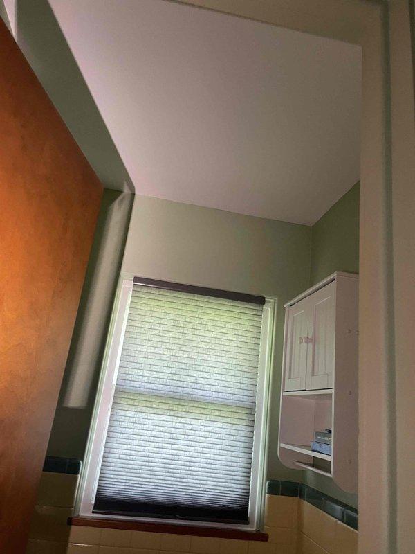 Conducted site assessment for new air conditioning system installation in single-story, 3-bedroom residence currently equipped with steam heating only. Evaluated attic space for equipment placement and ductwork routing, documented existing conditions including interior layout and structural considerations. Photographed utility areas and hallway access points to determine optimal installation pathway for refrigerant lines and condensate drainage. Prepared comprehensive estimate for complete AC system installation including outdoor condensing unit, indoor air handler, thermostat, and full ductwork distribution network to serve all living areas.