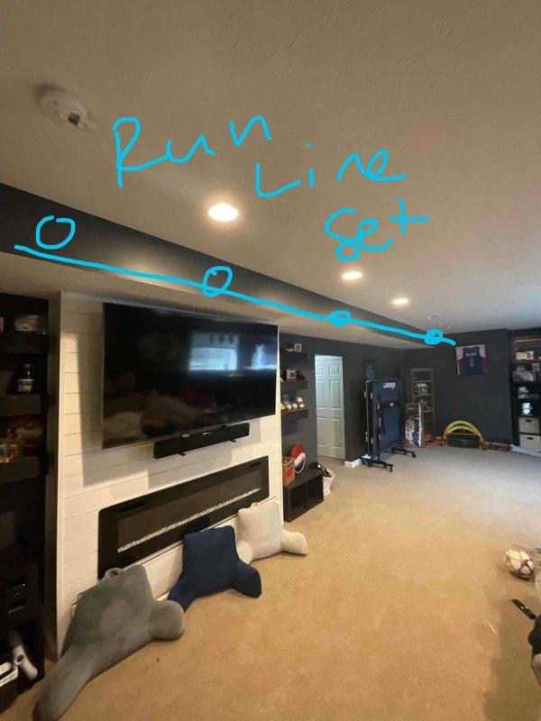 Conducted full system assessment for air conditioning replacement estimate due to unit surging and high energy consumption. Evaluated existing HVAC system location and assessed feasibility of relocating equipment during replacement. Documented current installation in unfinished utility area with exposed framing and existing copper line set routing, then mapped proposed line set path through finished basement living space to accommodate potential system relocation. Also evaluated water heater for replacement estimate as requested.