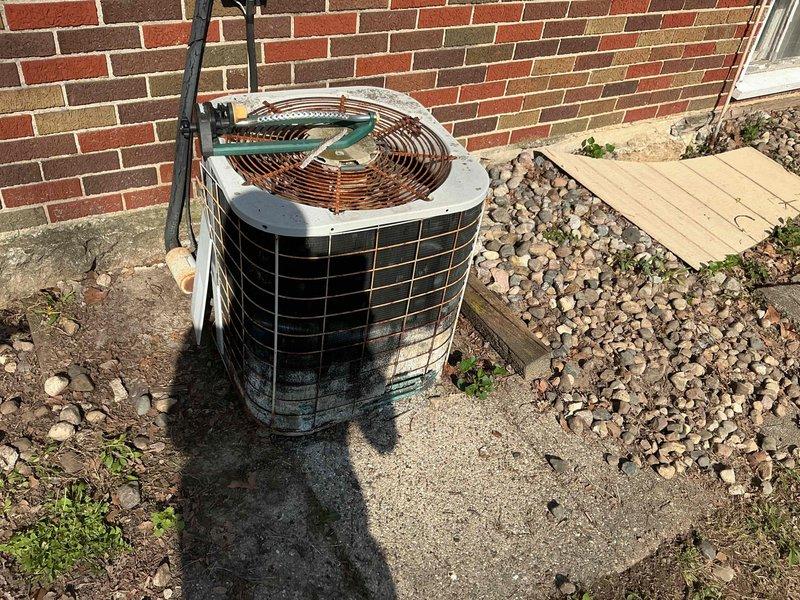 Provided estimate for complete HVAC system replacement including furnace and air conditioning unit under promotional offer. Existing 20+ year old equipment located in basement mechanical room with natural gas furnace currently operational but outdoor AC condenser unit non-functional. Assessment included evaluation of basement-installed furnace with existing ductwork, water heater proximity, and gas line configuration, as well as exterior condenser unit positioned on concrete pad adjacent to brick foundation with landscaping considerations for replacement access and installation.