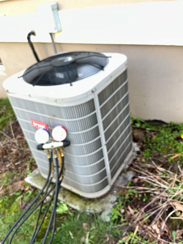 Completed annual preventative maintenance on residential split system air conditioning unit. Performed comprehensive system diagnostics including electrical testing with multimeter showing proper voltage readings, installed pressure gauges to verify refrigerant charge levels, and inspected outdoor condenser unit. Cleaned condenser coil fins, removed debris accumulation around unit base, and confirmed all mechanical and electrical components operating within manufacturer specifications.