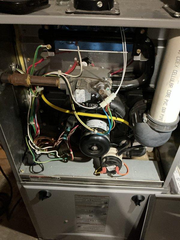 Completed annual heating maintenance on residential furnace system. Performed comprehensive inspection of internal components including blower motor assembly, gas valve, electrical connections, and control board. Verified proper electrical operation with multimeter reading of 35.01 volts, confirming system is functioning within normal parameters.
