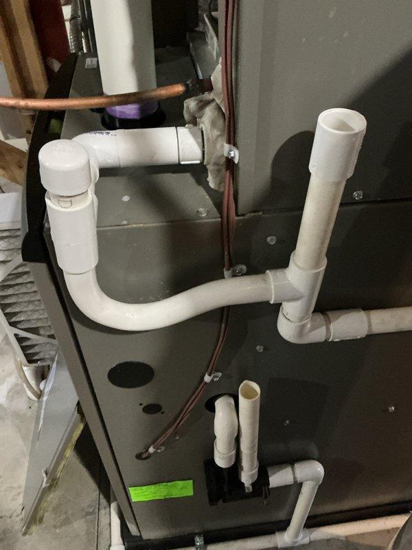 Completed spring AC tune-up on Lennox system with 2-year warranty coverage remaining through April 2028. Performed comprehensive maintenance inspection of indoor air handler unit in basement, verifying proper operation of furnace components, condensate drainage system, and refrigerant lines. Inspected outdoor condenser unit and documented significant accumulation of dirt and debris on mesh panel and coil surfaces requiring attention. System currently operating properly with all components functioning as designed.