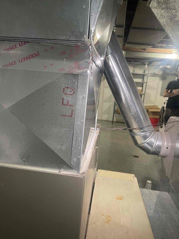 Conducted on-site evaluation for heat pump system replacement on 1,450 square foot residential property. Assessed existing 16-year-old central air conditioning unit and ductwork configuration in basement mechanical room to determine compatibility with proposed heat pump installation while retaining existing gas furnace for supplemental heating. Inspected galvanized metal ductwork system, air handler mounting, and insulated supply lines to verify structural integrity and capacity for hybrid heating system integration. Documented current HVAC infrastructure including sheet metal plenum connections, mechanical fasteners, and foil-faced insulation material. Evaluated electrical service capacity and refrigerant line routing requirements for heat pump conversion. Provided technical specifications and equipment recommendations for dual-fuel system configuration to meet customer timeline for installation within one month.