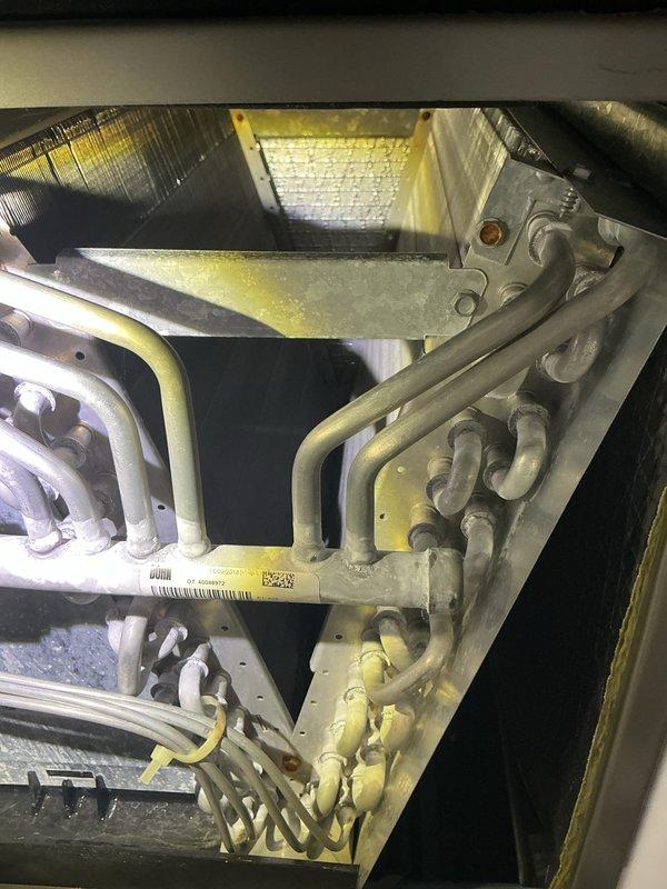 Completed annual cooling maintenance on rooftop HVAC unit. Inspected air filter, heat exchanger coils, and internal components; all equipment found in operational condition with normal wear patterns. System operating within specifications with no service issues identified.