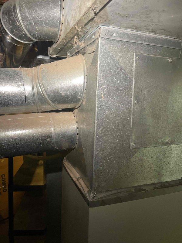 Provided comprehensive estimate for complete HVAC system replacement in basement location. Assessed existing 21-year-old natural gas furnace and air conditioning system, both non-operational. Evaluated current ductwork configuration including metal supply and return ducts with flexible insulated connections throughout unfinished basement space. Documented equipment specifications, existing installation layout, and system requirements for furnace and air conditioner replacement under promotional offer. Reviewed access considerations, utility connections, and necessary modifications for new equipment installation.