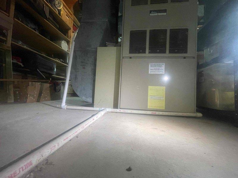 Provided estimate for replacement of 30-year-old non-functional furnace located in basement, with possible air conditioning system addition. Assessed existing air handler unit showing significant condensation and moisture accumulation on exterior surfaces, indicating potential humidity control issues in mechanical space. Recommended complete HVAC system replacement due to age and equipment failure.