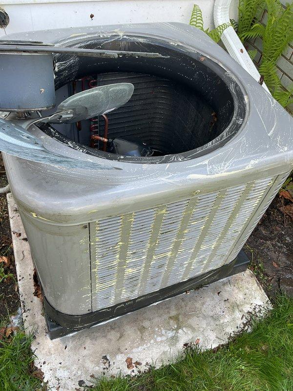 Completed annual cooling maintenance on outdoor air conditioning condenser unit. Performed comprehensive inspection of all major components including compressor, condenser coil, fan assembly, and refrigerant lines. Cleaned exterior panels and housing, removing algae growth and debris accumulation from louver vents and base area. Inspected copper refrigerant lines showing normal patina development with no visible leaks. Verified condenser coil condition and cleared debris from interior compartment. Checked fan motor operation and blade assembly for proper function. Assessed electrical connections and wiring integrity. Unit operational at time of service completion.