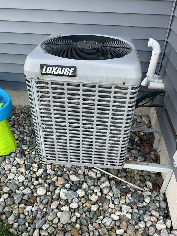 Completed comprehensive AC tune-up on 8-year-old Luxaire central air conditioning system. Performed standard maintenance protocol including refrigerant pressure checks using manifold gauges, inspected condensing unit exterior condition, verified proper airflow through louvered panels and top-mounted fan assembly, and examined electrical disconnect and line set connections. System operating within normal parameters with no deficiencies noted.