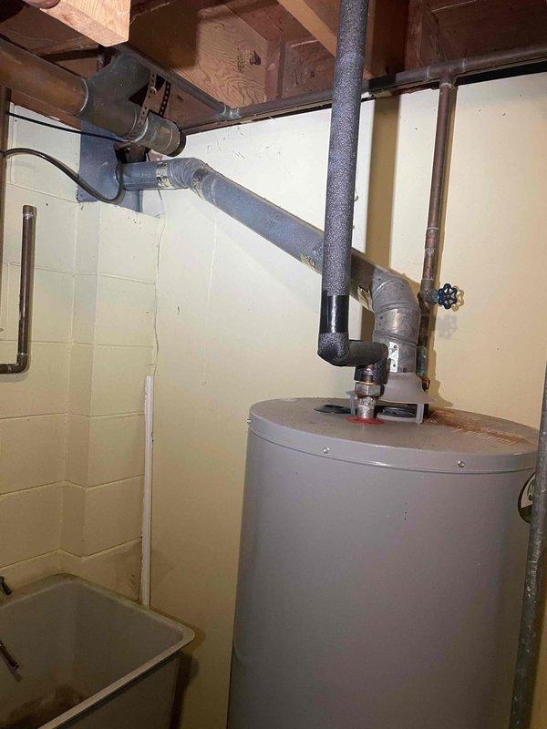 Conducted comprehensive assessment of existing furnace system for replacement estimate. Evaluated current Energy Star-rated equipment, documented equipment specifications and measurements, and assessed installation configuration including venting system with PVC piping. Inspected surrounding mechanical room infrastructure, including water heater and associated plumbing connections, to determine spatial requirements and potential installation considerations for new furnace unit. Photographed existing equipment condition and clearances to support accurate equipment sizing and replacement proposal.