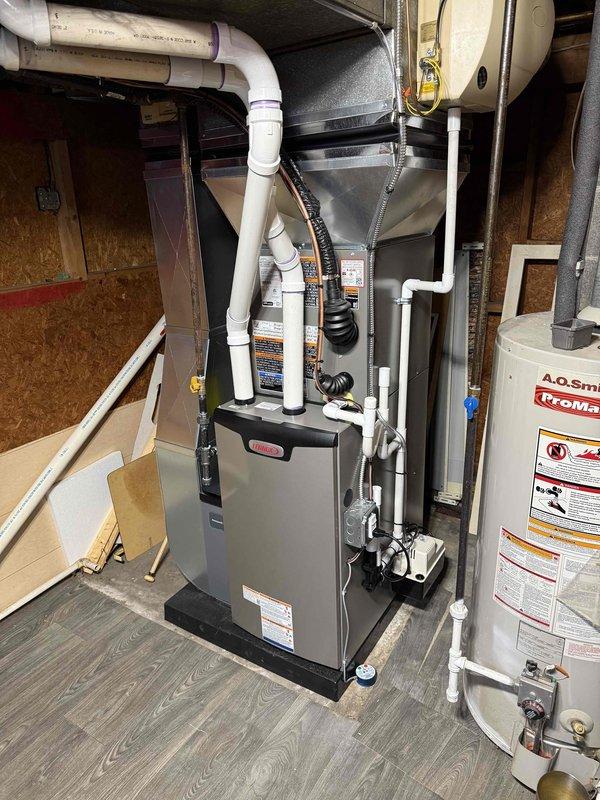 Completed full HVAC system installation including a 70,000 BTU furnace and 2-ton air conditioning unit. Installed furnace in basement utility area with proper PVC venting and ductwork connections, positioned unit to left side of existing water heater. Mounted outdoor condenser unit on concrete pad with rubber isolation pad, completed all refrigerant line connections and electrical hookups. Verified all connections, tested system operation, and ensured compliance with mechanical permit requirements.
