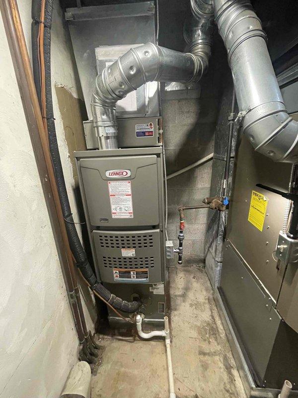 Completed furnace-only installation in residential basement utility room. Installed new Lennox 90,000 BTU high-efficiency furnace unit, securing equipment to concrete block wall per manufacturer specifications. Connected all supply and return ductwork using galvanized steel sections and appropriate elbows for proper airflow distribution throughout the system. Ran and connected gas supply line with shutoff valve for fuel delivery. Installed electrical disconnects and wiring to power unit and control systems. Routed condensate drain lines and refrigerant lines as needed for system operation. Verified all connections for proper fitment and sealed ductwork transitions to prevent air leakage. Tested furnace operation including ignition sequence, burner performance, and safety controls. Confirmed proper venting configuration and clearances meet code requirements. Obtained necessary mechanical and electrical permits prior to installation. All work completed to local building codes and manufac