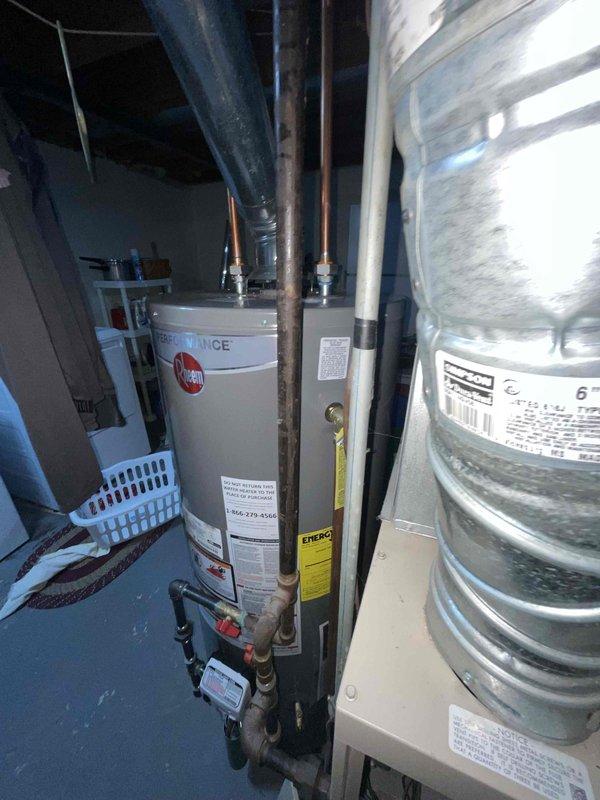 Conducted site evaluation for air conditioning replacement estimate in basement mechanical room. Assessed existing HVAC system configuration including furnace unit, ductwork layout, and available space for new equipment installation. Documented current system setup with metallic air handler, existing supply and return plenum connections, and flexible duct routing to determine compatibility requirements for proposed AC unit replacement.