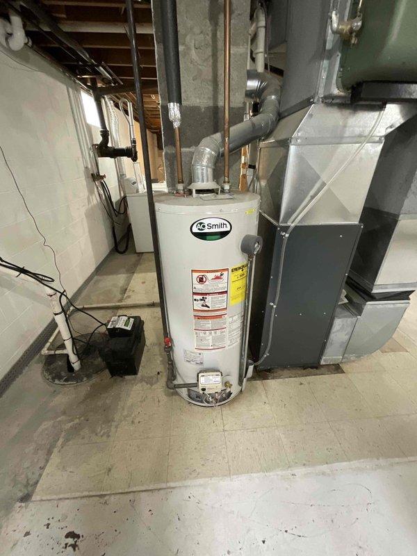 Conducted on-site assessment of existing A.O. Smith tank-style water heater in basement mechanical room to provide estimate for replacement with electric tankless unit. Evaluated current installation including copper supply lines, gas connections, electrical requirements, venting configuration, and available space constraints. Documented existing equipment specifications and mechanical room layout to determine feasibility and scope of converting from conventional tank water heater to tankless electric system.