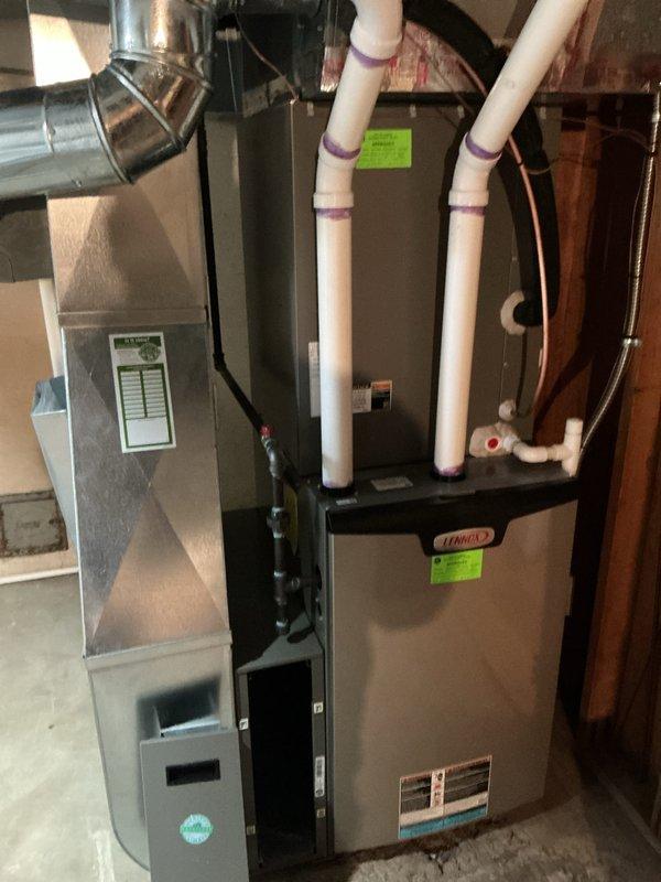Completed scheduled Air Care Maintenance on residential Lennox HVAC system located in basement utility area. Performed comprehensive system inspection including visual examination of furnace, air handler, and associated components. Removed and replaced heavily soiled air filter showing significant dust accumulation and discoloration from extended use. Inspected PVC condensate drainage lines and venting system with purple mounting straps for proper securing and functionality. Verified all electrical connections, ductwork connections, and system mounting hardware. Documented system condition through photographic records showing equipment specifications and maintenance performed. All components found operating within normal parameters with no immediate service concerns identified following filter replacement and routine inspection protocol.