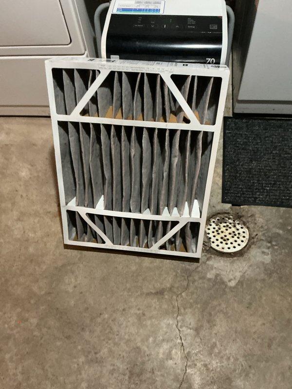 Completed scheduled Air Care Maintenance on residential Lennox HVAC system located in basement utility area. Performed comprehensive system inspection including visual examination of furnace, air handler, and associated components. Removed and replaced heavily soiled air filter showing significant dust accumulation and discoloration from extended use. Inspected PVC condensate drainage lines and venting system with purple mounting straps for proper securing and functionality. Verified all electrical connections, ductwork connections, and system mounting hardware. Documented system condition through photographic records showing equipment specifications and maintenance performed. All components found operating within normal parameters with no immediate service concerns identified following filter replacement and routine inspection protocol.