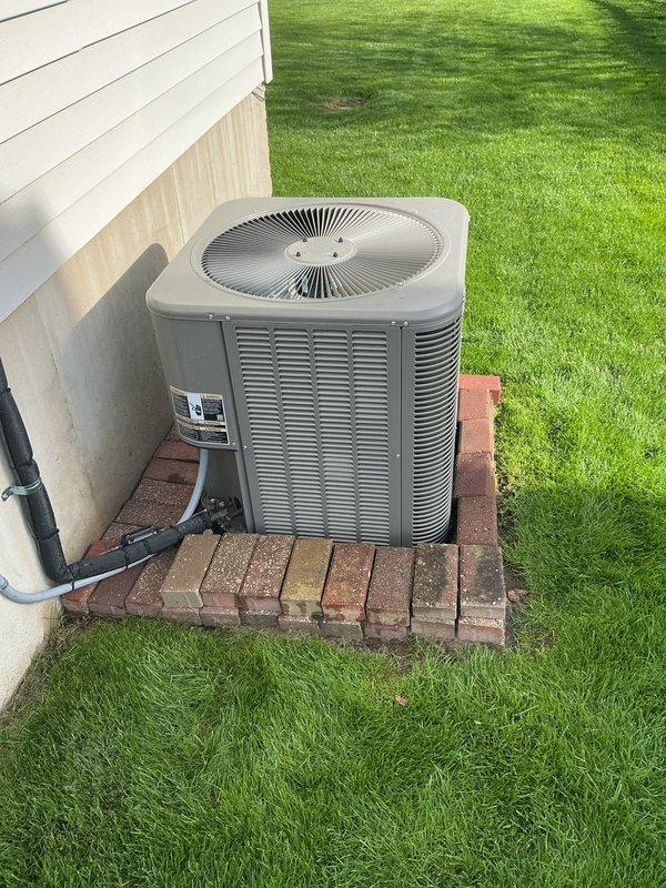 Completed annual cooling maintenance on Lennox outdoor condensing unit. Performed comprehensive system inspection including visual assessment of unit condition, electrical connections, and refrigerant lines. Unit found in good operating condition with clean coils and proper installation on brick paver pad. Condensate drain line confirmed clear and functioning properly. System operating within normal parameters.