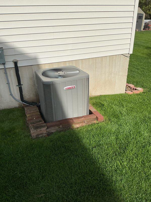 Completed annual cooling maintenance on Lennox outdoor condensing unit. Performed comprehensive system inspection including visual assessment of unit condition, electrical connections, and refrigerant lines. Unit found in good operating condition with clean coils and proper installation on brick paver pad. Condensate drain line confirmed clear and functioning properly. System operating within normal parameters.
