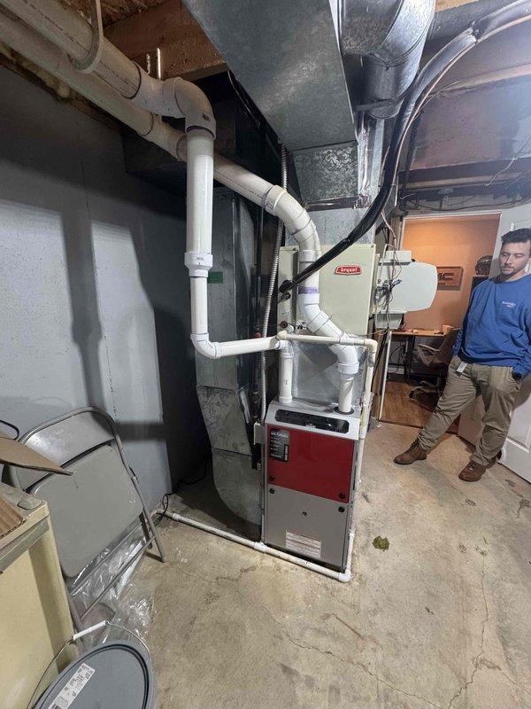 Completed HVAC system assessment for air conditioning and furnace replacement in basement location. Customer reported poor airflow from both AC and furnace units, with aging equipment requiring full system replacement. Documented existing installation including furnace with cabinet-style housing, ductwork configuration, condensate drainage lines, and air handler setup. Provided comprehensive replacement estimate for new system to address inadequate airflow issues and equipment age concerns.