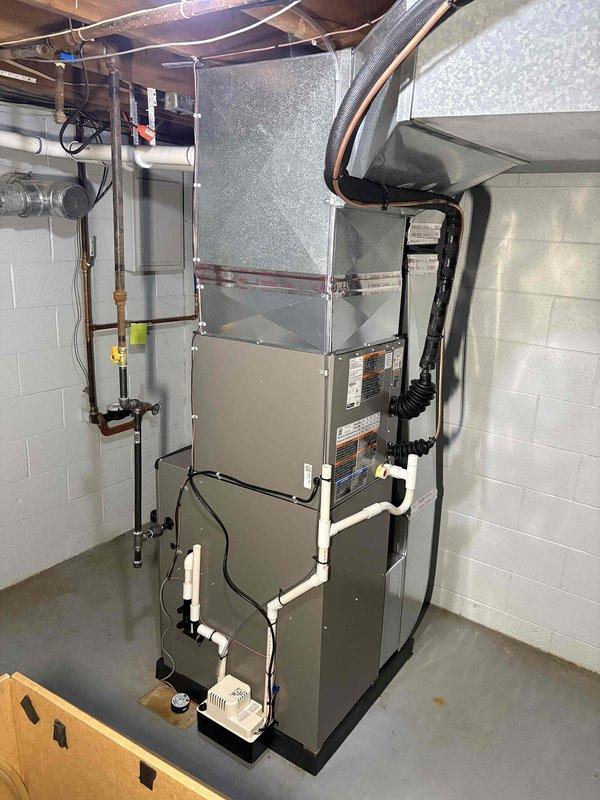 Completed full HVAC system installation in basement utility area, including 70,000 BTU gas furnace and 2-ton air conditioning unit. Secured all required mechanical and electrical permits prior to installation. Mounted furnace on platform base with proper clearances, connected PVC condensate drainage lines, and installed refrigerant line set with copper piping. Configured flexible ductwork to distribution system with metal banding and proper support from ceiling joists. Completed all electrical connections and reconnected system components to existing infrastructure. Verified proper operation of both heating and cooling systems upon startup. Installation meets all applicable building codes and manufacturer specifications.