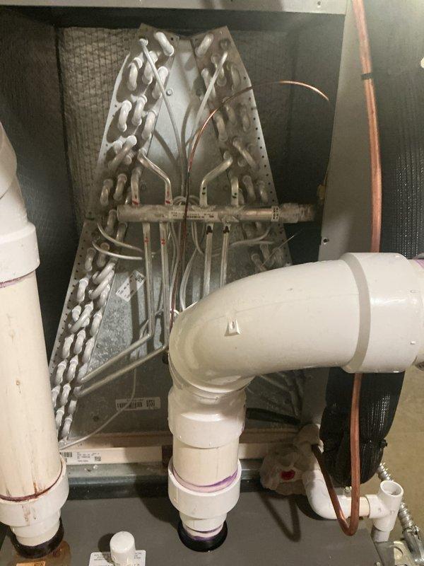 Completed annual cooling maintenance on residential HVAC system. Performed comprehensive inspection of evaporator coil, A-frame assembly, refrigerant lines, and all associated PVC drainage piping. Verified proper operation of furnace, air handler, and integrated mechanical systems in basement installation.