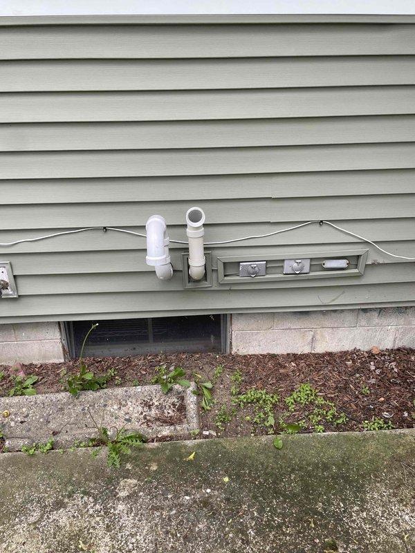Successfully completed installation of a 2.5-ton air conditioning system with matching evaporator coil in residential basement mechanical room. Installed new dark gray air handler unit adjacent to existing beige furnace, connected white PVC condensate drainage lines, and integrated system with existing ductwork infrastructure including flexible insulated ducts. Exterior work included mounting new disconnect box on home's siding and routing refrigerant linesets and electrical connections through foundation wall. Verified proper refrigerant charge, tested system operation and airflow, and confirmed all electrical connections were secure. All work performed under mechanical permit with reconnection of electrical components completed separately.