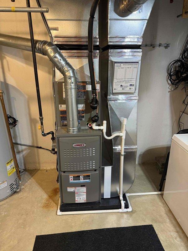 Completed full HVAC system installation including a Lennox 90,000 BTU gas furnace and 2-ton air conditioning unit. Installed furnace in basement mechanical room with proper venting, gas line connection, electrical conduit, and PVC condensate drainage; mounted outdoor Lennox condenser unit on equipment pad with refrigerant line connections and electrical service. System was pressure tested, refrigerant lines were charged, all connections were verified for proper operation, and unit was commissioned to manufacturer specifications.