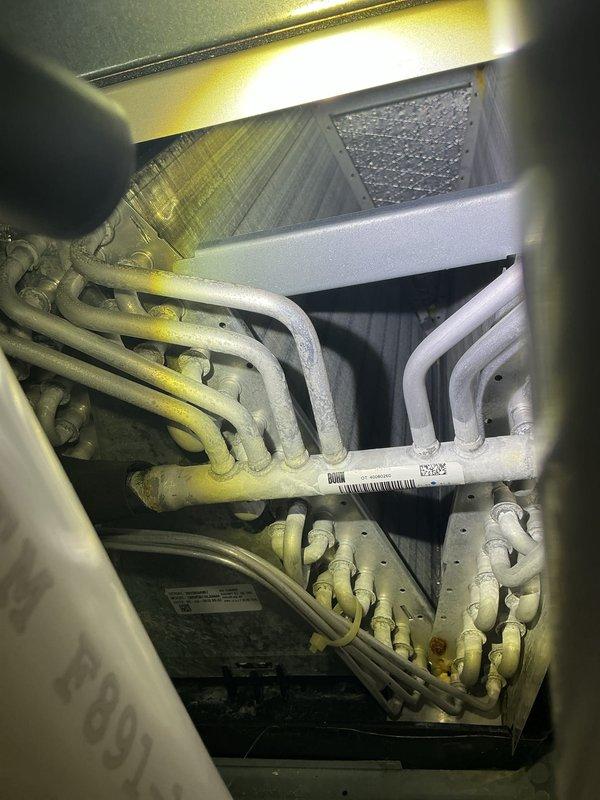 Completed annual cooling maintenance on HVAC heat pump unit. Inspected refrigerant lines, evaporator coil, and heat exchanger assembly, confirming proper operation and no visible leaks. Verified condensate drain lines are clear and functioning correctly, and documented system condition with photos showing all major components in operational status.