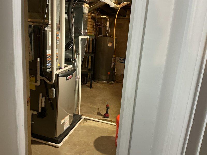 Completed full HVAC system installation in basement mechanical room, including 70,000 BTU gas furnace with humidifier integration and 2-ton air conditioning unit configured for right-side discharge. Installed all necessary PVC condensate drainage, venting systems, and refrigerant line connections. Reconnected existing gas lines using flexible connectors and verified all electrical connections to new equipment. All mechanical permits obtained prior to installation and system tested for proper operation upon completion.