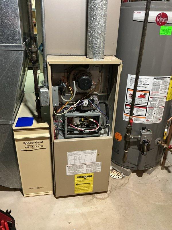 Responded to no-heat call on 22-year-old forced air furnace. Upon arrival, confirmed unit would not initiate heating cycle when thermostat was raised. Removed front access panel and performed diagnostic inspection of internal components including blower motor, electrical connections, and control board. Identified failed ignition system preventing burner operation. Due to age of equipment and availability of replacement parts for this legacy system, advised homeowner of repair options and recommended evaluation of full system replacement given unit has exceeded typical service life expectancy. Documented equipment condition with photographs showing internal components and overall installation. Unit remains non-operational pending homeowner decision on repair versus replacement.