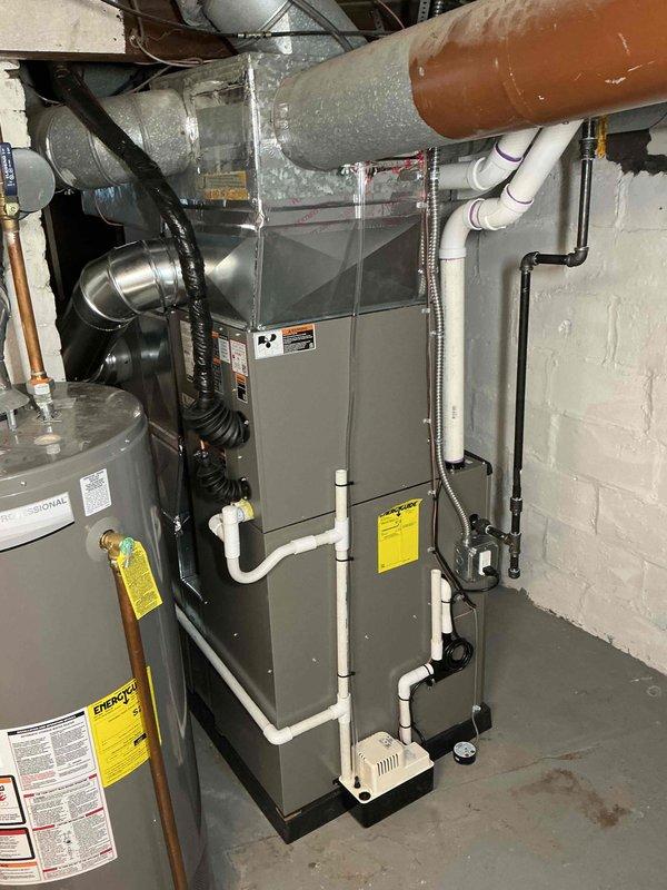Completed full HVAC system installation in basement mechanical room, including Lennox 70,000 BTU furnace (Model CK40CT-24B-71) with R-454B refrigerant and 2-ton air conditioning unit with rear discharge configuration. Installed humidifier, established new electrical circuit with conduit and wiring, and connected all ductwork including insulated supply lines. Coordinated mechanical and electrical permits prior to installation. All PVC condensate drainage, refrigerant lines, and electrical connections completed per manufacturer specifications and local code requirements.