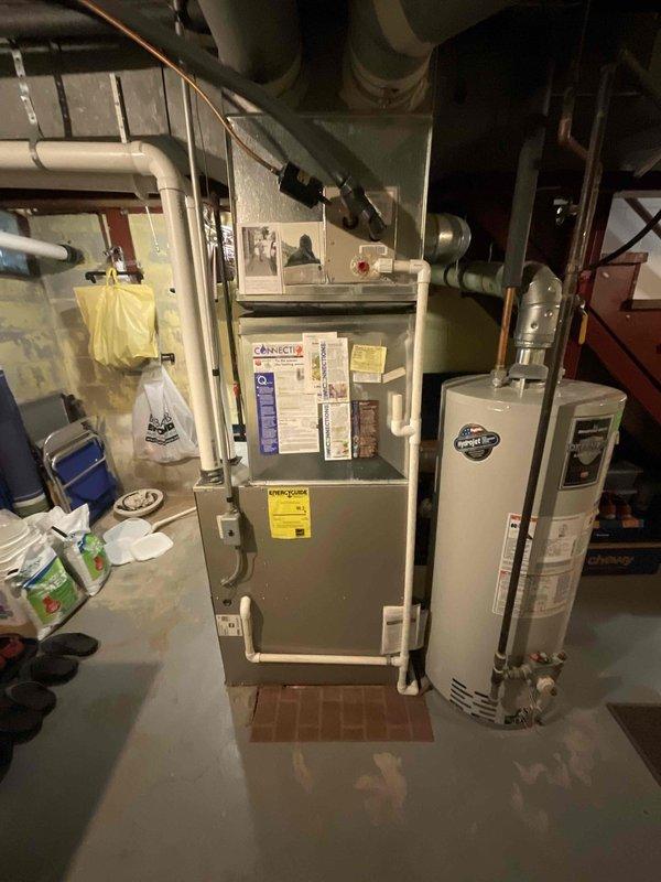 Conducted estimate for air conditioning system replacement on 28-year-old residential HVAC unit in preparation for upcoming summer season. Inspected existing basement-installed equipment including furnace, associated ductwork, and electrical infrastructure to assess compatibility requirements for new AC installation. Documented current system configuration and utility room layout with photographic records to support replacement proposal specifications.