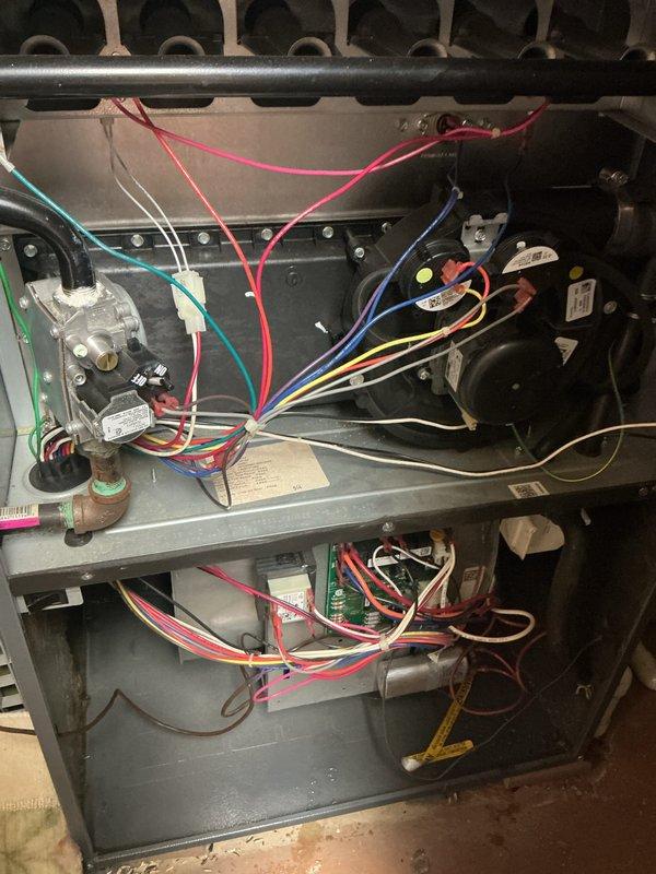 Completed comprehensive HVAC maintenance inspection on residential furnace system. Removed access panels to perform thorough examination of all internal components including blower motor assembly, gas valve, draft inducer motor, electrical connections, and control board. Inspected wiring harnesses throughout unit, verified proper connections of all colored wire runs to respective components, and documented system configuration. All mechanical and electrical components found to be in operational condition with no immediate repairs required.