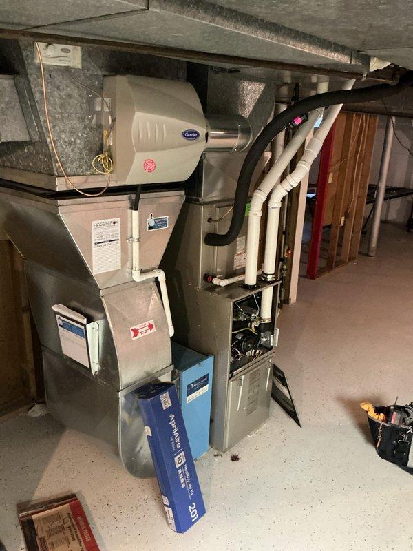 Completed comprehensive tune-up service on Carrier furnace system located in basement, including inspection of humidifier and Space-Gard air filtration components. Verified proper operation of all system components, checked gas connections, inspected PVC venting, and confirmed all safety controls and manufacturer specifications were within normal parameters. System is operating efficiently with no issues identified at this time.