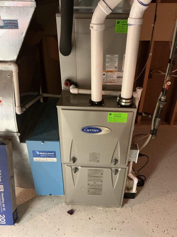 Completed comprehensive tune-up service on Carrier furnace system located in basement, including inspection of humidifier and Space-Gard air filtration components. Verified proper operation of all system components, checked gas connections, inspected PVC venting, and confirmed all safety controls and manufacturer specifications were within normal parameters. System is operating efficiently with no issues identified at this time.