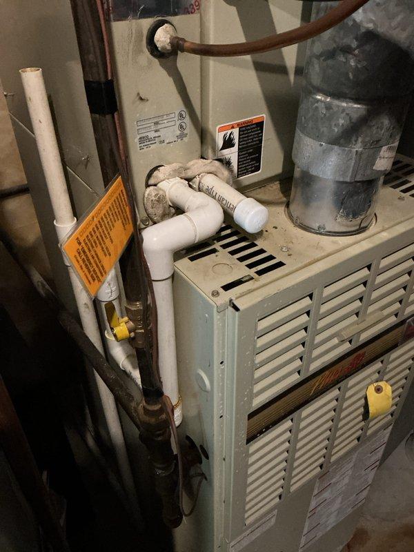 Completed annual maintenance on air conditioning system. Inspected indoor furnace unit and associated components including refrigerant lines, condensate drain system, and electrical connections. Cleaned outdoor condenser unit which had significant accumulation of pine needles and organic debris surrounding compressor and capacitor. Removed debris from condenser base, verified fan operation, checked refrigerant line connections, and confirmed all safety labels and warnings were intact. System operational and ready for cooling season.