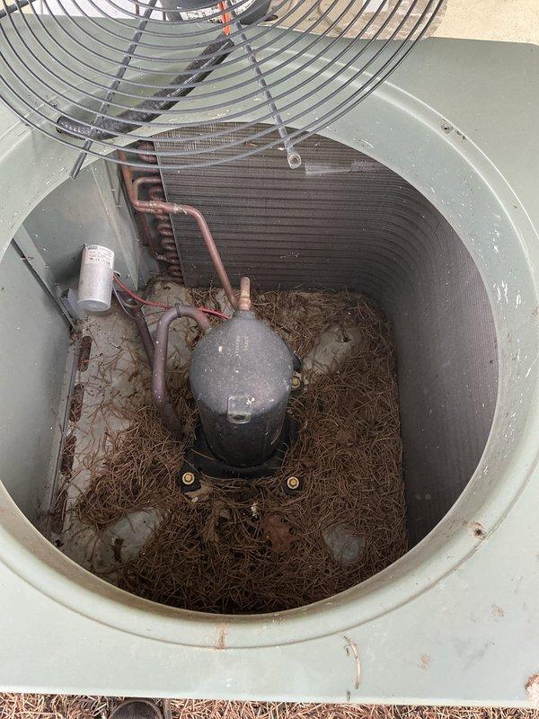 Completed annual maintenance on air conditioning system. Inspected indoor furnace unit and associated components including refrigerant lines, condensate drain system, and electrical connections. Cleaned outdoor condenser unit which had significant accumulation of pine needles and organic debris surrounding compressor and capacitor. Removed debris from condenser base, verified fan operation, checked refrigerant line connections, and confirmed all safety labels and warnings were intact. System operational and ready for cooling season.