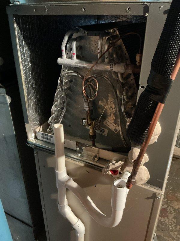 Completed annual cooling maintenance on residential HVAC system. Performed comprehensive inspection of indoor air handler unit, documenting significant dust accumulation and grime on blower motor assembly and internal components. Inspected outdoor condenser unit, verified proper operation of fan assembly, and applied coil cleaner to exterior surfaces. Checked refrigerant lines, condensate drain system with PVC U-trap configuration, and electrical connections throughout both units for proper function and safety compliance.
