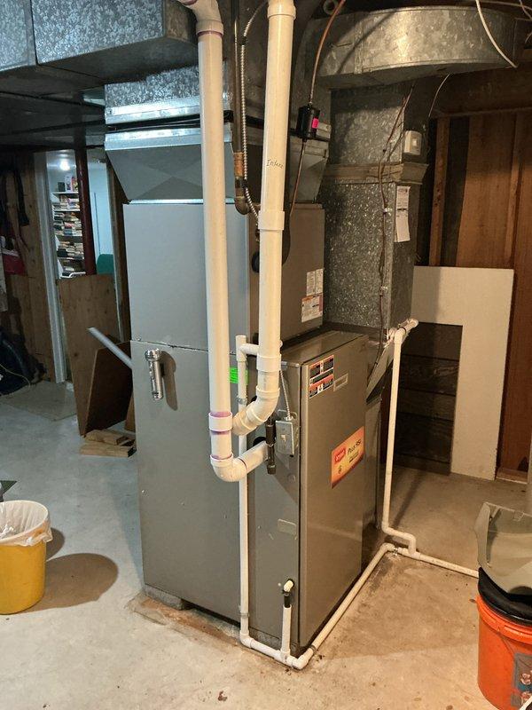 Performed annual cooling maintenance on residential HVAC system. Inspected evaporator coil in attic air handler, noting dust accumulation on coil surfaces and serpentine tubing assembly. Checked furnace and air handler equipment in basement mechanical room, verified proper operation of condensate drainage system and PVC piping connections. Replaced air filter and documented equipment condition with photographs for service records.