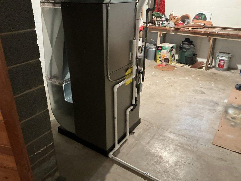 Completed full HVAC system installation including a 70,000 BTU gas furnace positioned in the basement utility area and a 2-ton Lennox air conditioning condenser unit installed at the rear of the property. The furnace was equipped with white PVC venting routed along the unit, and all refrigerant lines were connected between the indoor and outdoor components. All mechanical connections were completed, system was tested for proper operation, and installation was performed in accordance with permit requirements for mechanical work only, utilizing existing electrical connections.