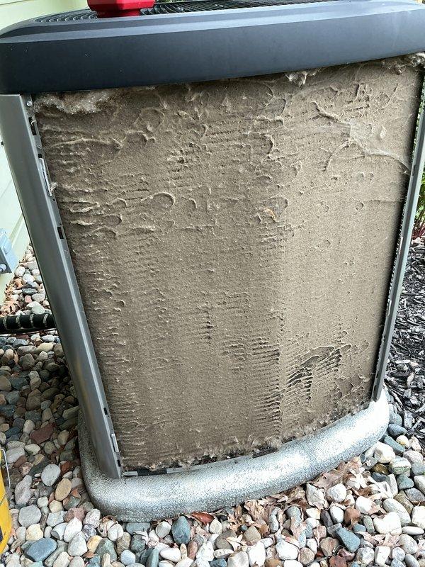 Completed annual cooling maintenance on residential air conditioning system. Inspected outdoor condenser unit, noting heavy accumulation of dirt and debris on exterior filter panel which was cleaned during service. Performed standard ACM checklist including inspection of condenser coils, verification of proper unit operation, and documentation with photographic records of equipment condition before and after service.