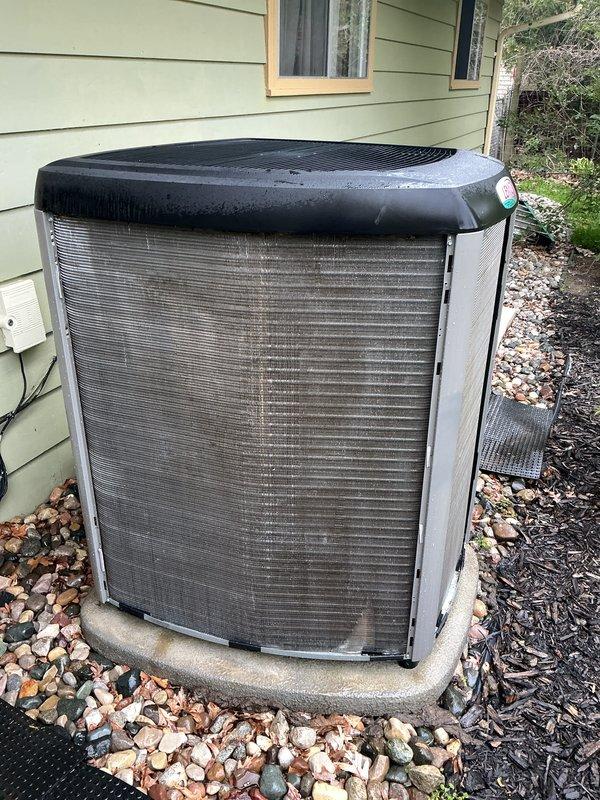 Completed annual cooling maintenance on residential air conditioning system. Inspected outdoor condenser unit, noting heavy accumulation of dirt and debris on exterior filter panel which was cleaned during service. Performed standard ACM checklist including inspection of condenser coils, verification of proper unit operation, and documentation with photographic records of equipment condition before and after service.