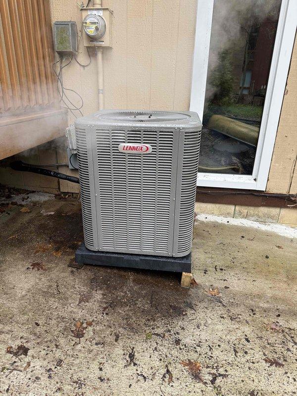 Completed full HVAC system installation including a Lennox 90,000 BTU high-efficiency furnace with humidifier in the basement mechanical room and a Lennox 3-ton air conditioning condenser unit positioned on a concrete pad at the rear exterior of the residence. All equipment was professionally mounted, PVC intake and exhaust venting installed for the furnace, electrical connections completed including outdoor disconnect, and existing ductwork reconnected to ensure proper system operation.