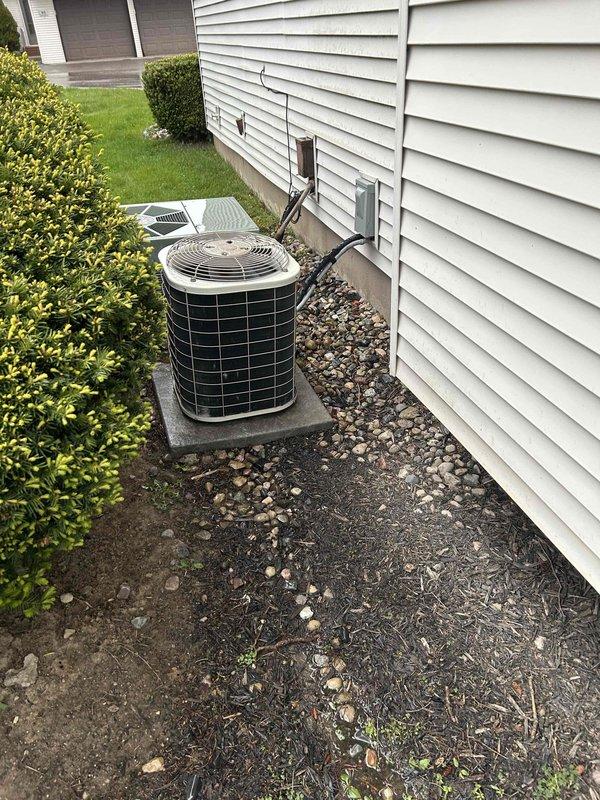 Completed comprehensive tune-up on 21-year-old residential air conditioning system located on exterior concrete pad. Performed full system inspection, cleaned condenser coils, checked refrigerant levels, tested electrical connections, verified proper airflow through both outdoor units, and confirmed all components operating within manufacturer specifications.