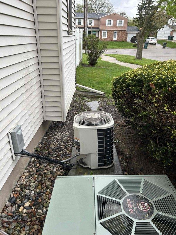 Completed comprehensive tune-up on 21-year-old residential air conditioning system located on exterior concrete pad. Performed full system inspection, cleaned condenser coils, checked refrigerant levels, tested electrical connections, verified proper airflow through both outdoor units, and confirmed all components operating within manufacturer specifications.