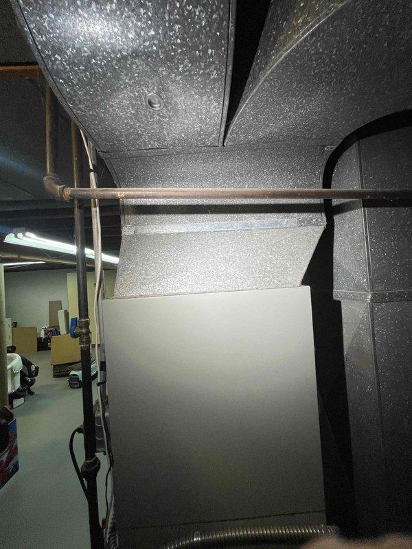 Conducted comprehensive assessment of 27-year-old residential furnace system experiencing operational failure with burners igniting then shutting down after buzzing sound with no heat delivery or airflow from vents. Evaluated HVAC equipment in basement mechanical room, documented existing furnace and ductwork configuration including flexible metallic ductwork with visible condensation indicating potential humidity concerns. Provided replacement estimate for complete furnace system upgrade, discussed available equipment options and promotional offerings for single-family residential installation.