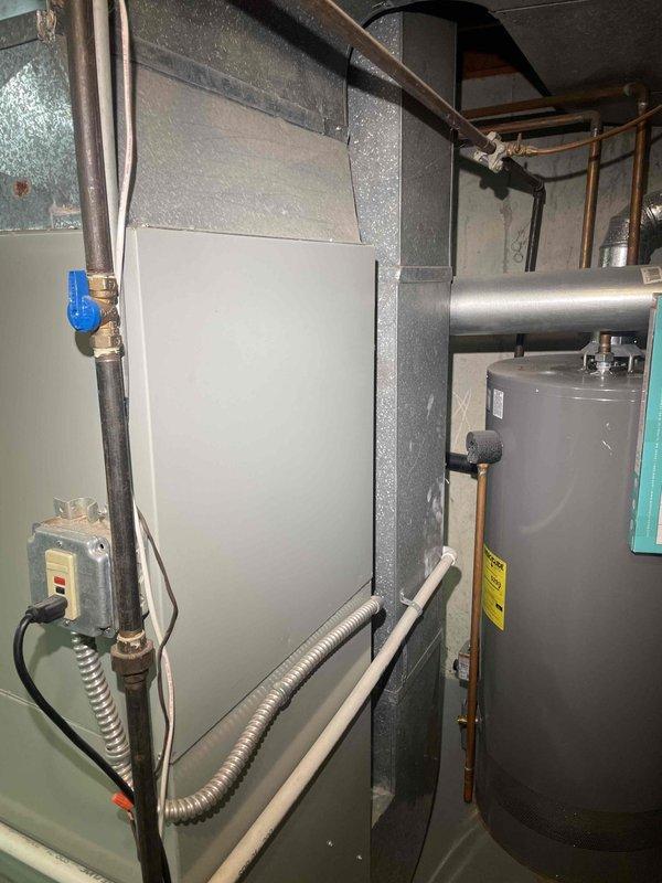 Conducted comprehensive assessment of 27-year-old residential furnace system experiencing operational failure with burners igniting then shutting down after buzzing sound with no heat delivery or airflow from vents. Evaluated HVAC equipment in basement mechanical room, documented existing furnace and ductwork configuration including flexible metallic ductwork with visible condensation indicating potential humidity concerns. Provided replacement estimate for complete furnace system upgrade, discussed available equipment options and promotional offerings for single-family residential installation.